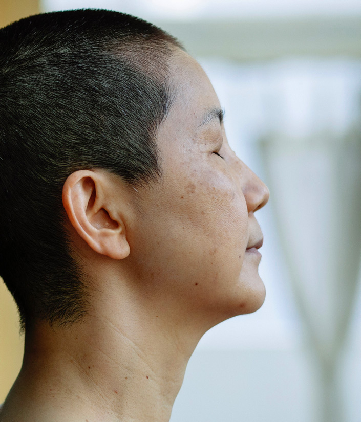 middle aged asian woman with eyes closed
